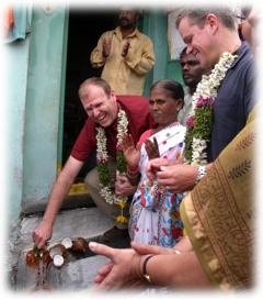 Water.org co-founders Gary White and Matt Damon join Hyderabad slum residents in celebrating their new water connection.